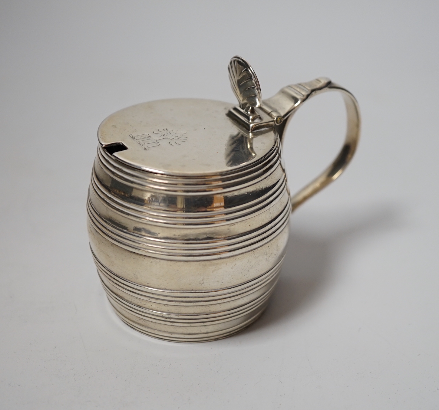 A George III silver barrel shaped mustard pot, Thomas Daniell, London, 1780, 8cm, with later blue glass liner.